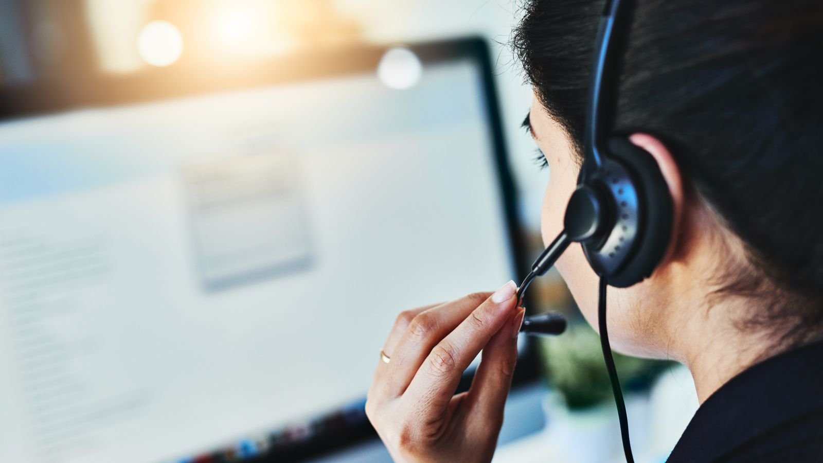 Rearview shot of a young woman working in a call centre
