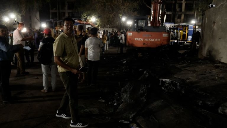 Neville Lazarus is at the crash site in Ahmedabad, where crowds are surrounding the multi-storey building - a medical facility - and looking