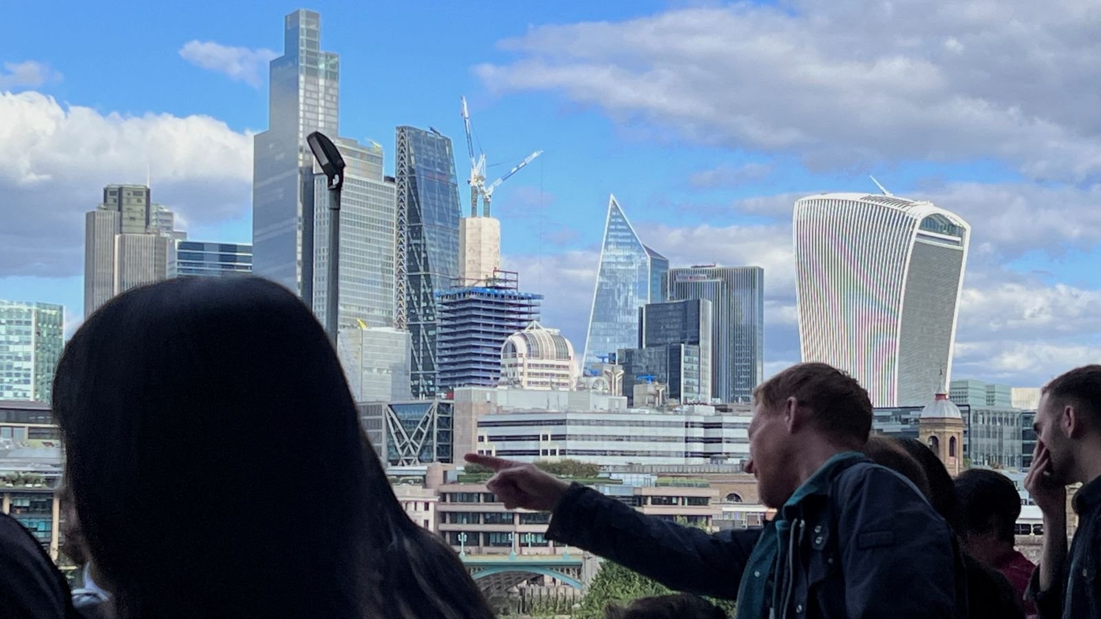 People look at a a view of the City of London skyline in London, Britain, September 23, 2023. REUTERS/Suzanne Plunkett