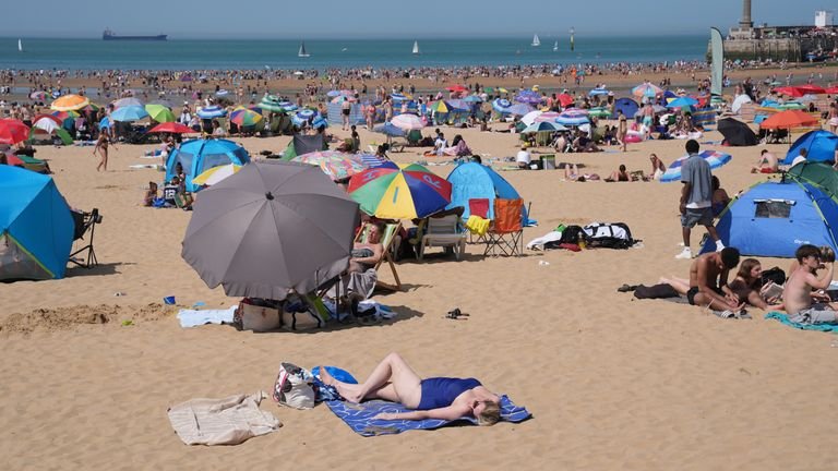 People enjoy the warm weather on a beach in Margate, Kent. Pic: PA