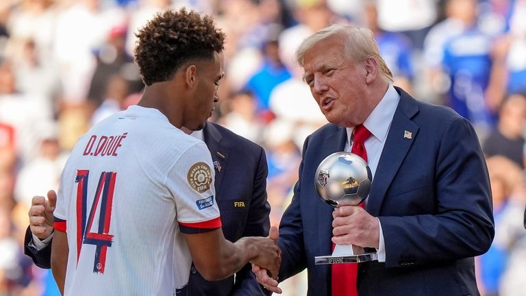 Mr Trump presents Desire Doue with the silver ball trophy. Pic: AP