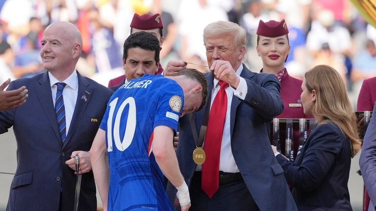 Donald Trump gives Cole Palmer his winner's medal. Pic: AP