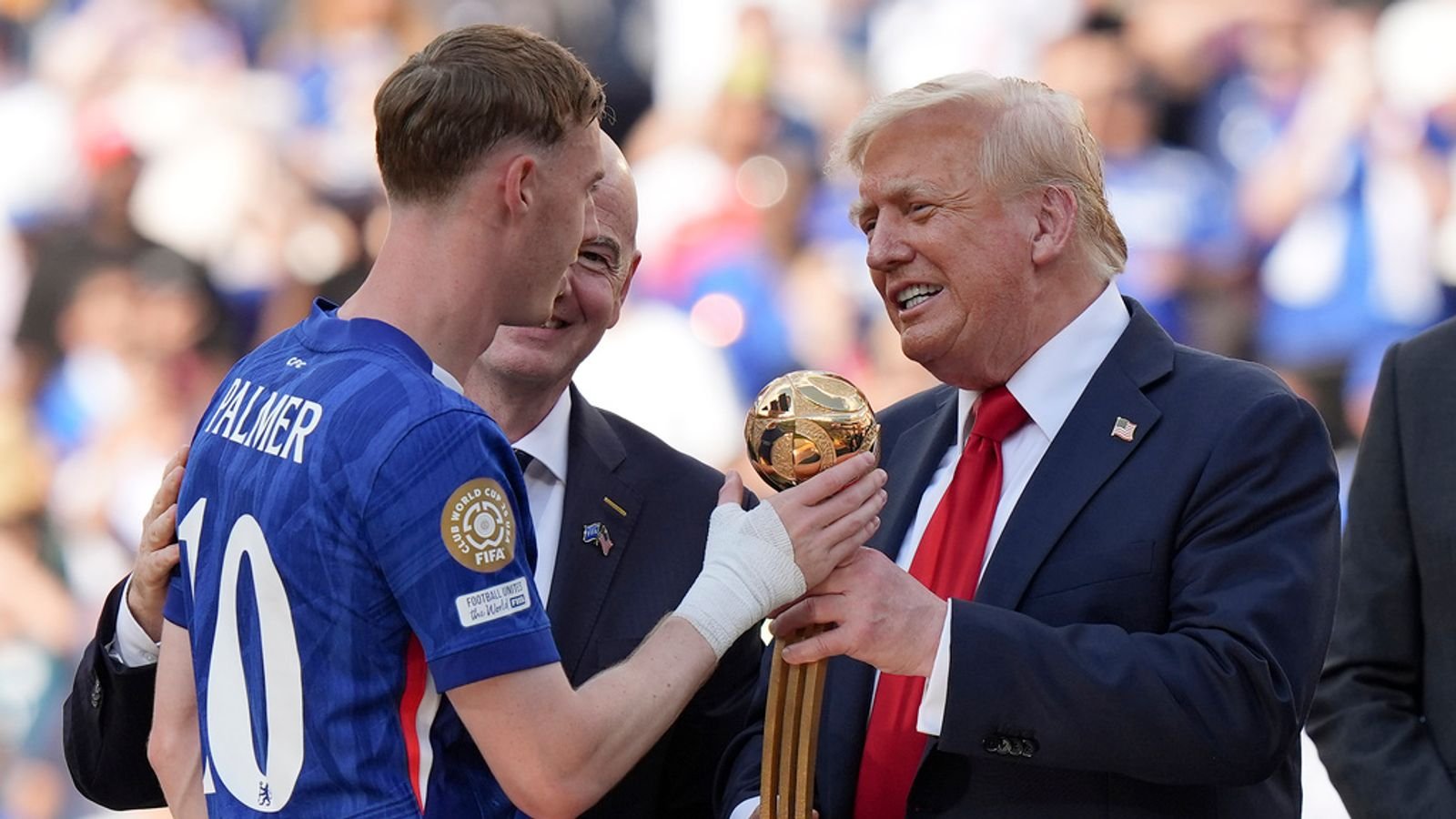 Mr Trump gives Cole Palmer the golden ball trophy. Pic: AP