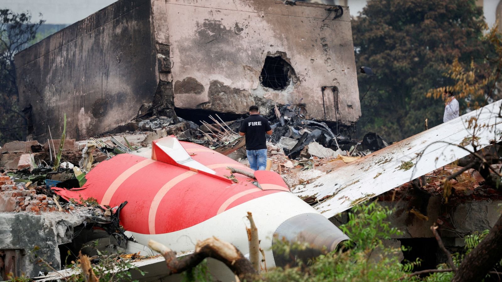 FILE PHOTO: A fire officer stands next to the crashed Air India Boeing 787-8 Dreamliner aircraft, in Ahmedabad, India, June 13, 2025. REUTER