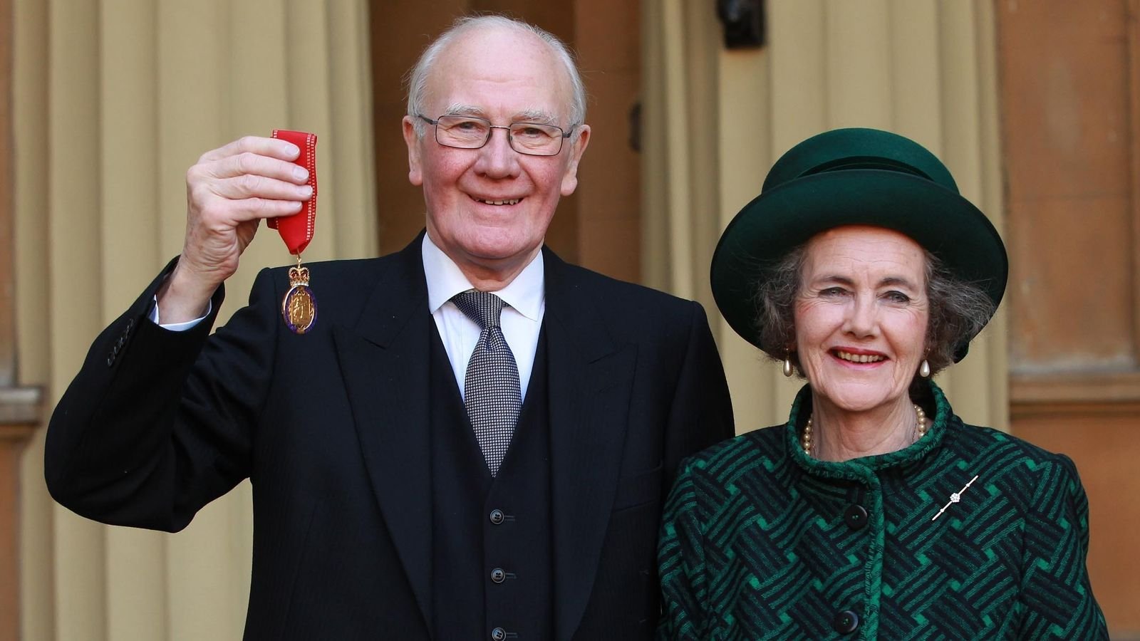 Sir Menzies Campbell holds his medal, with his wife Lady Elspeth Campbell, after being made a Companion of Honour in 2013