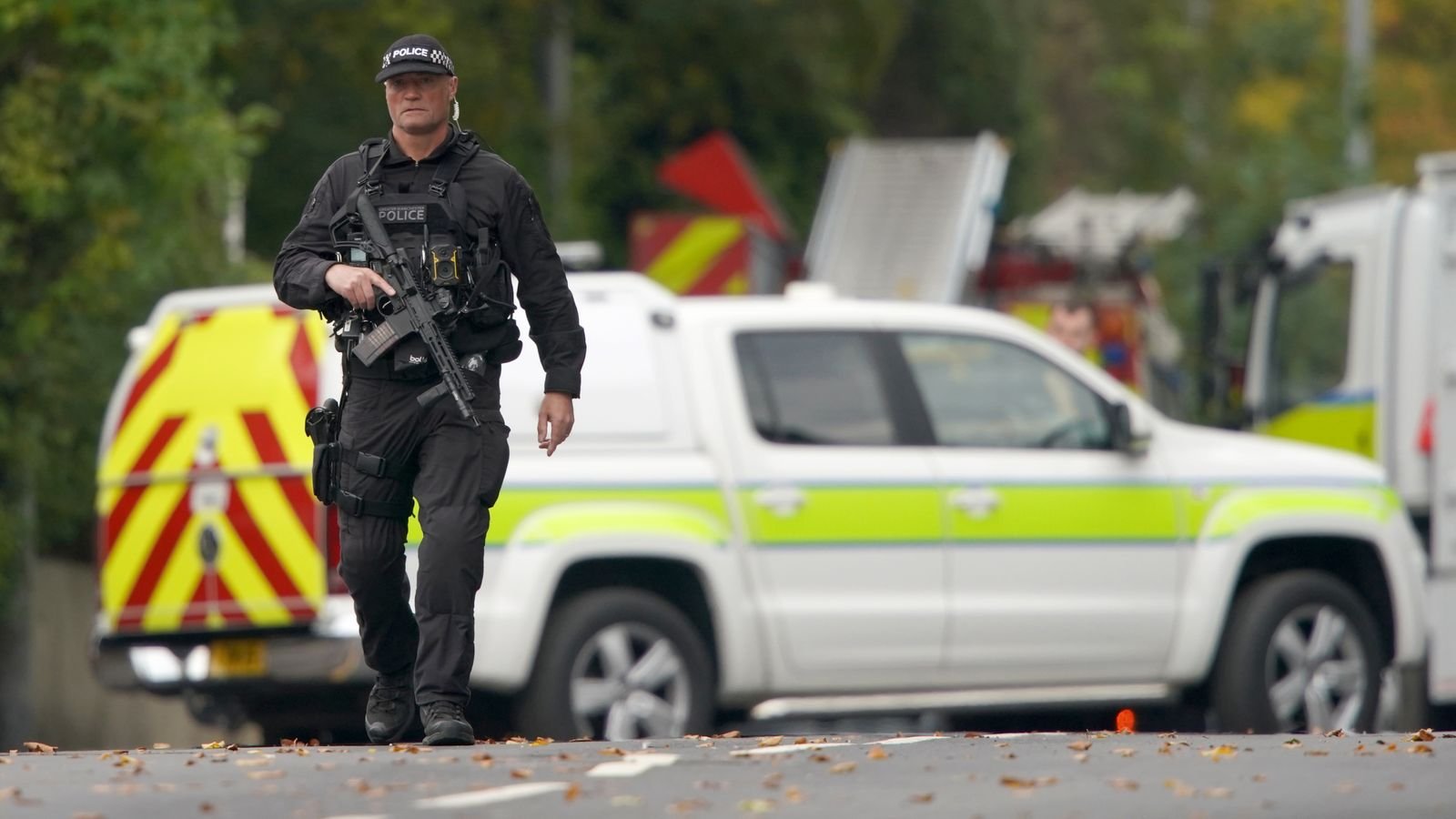 An armed police officer patrols near the scene at Heaton Park Hebrew Congregation Synagogue. Pic: AP