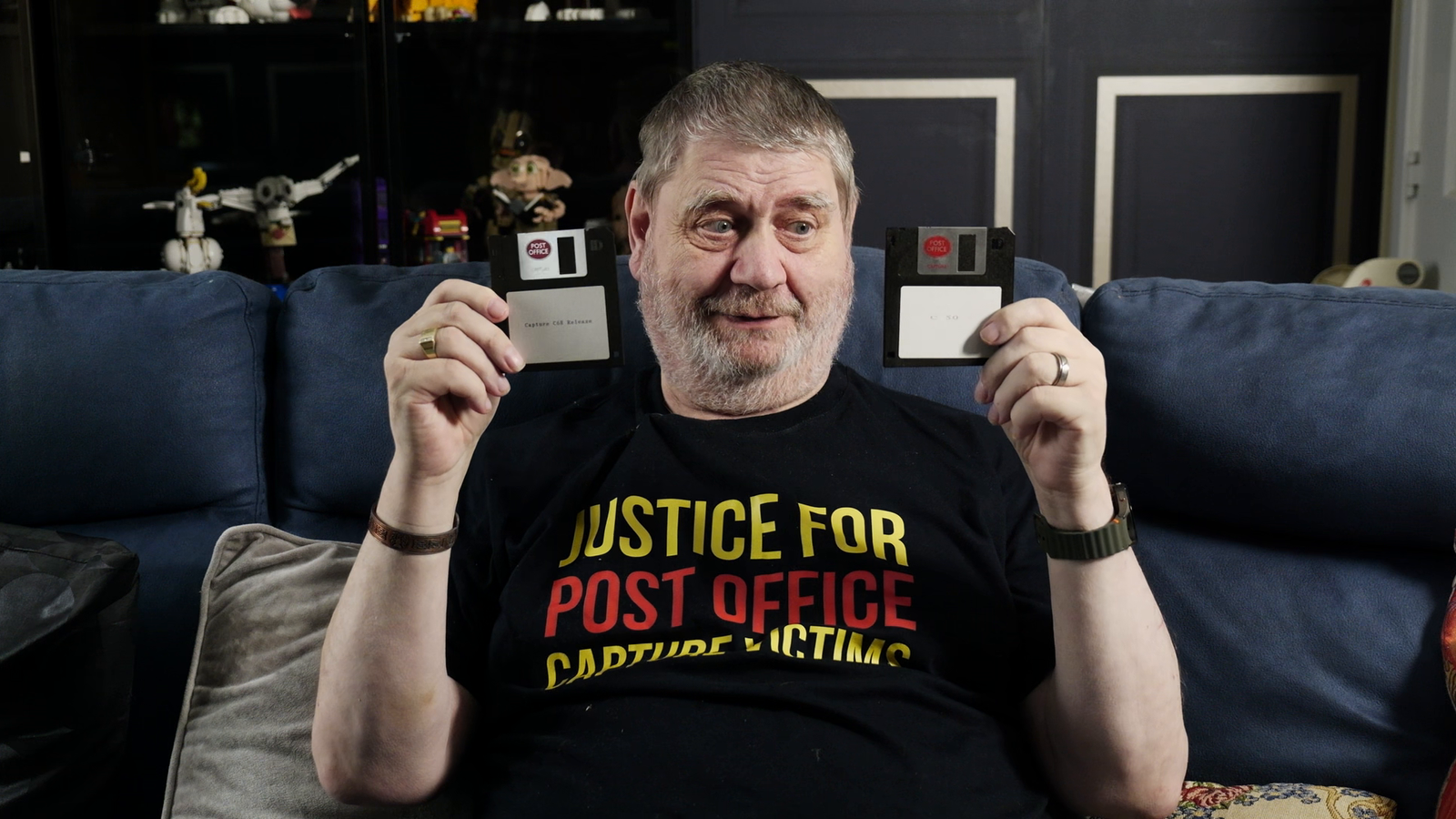 Mr Marston holds up computer disks which store the Capture software at the centre of the scandal