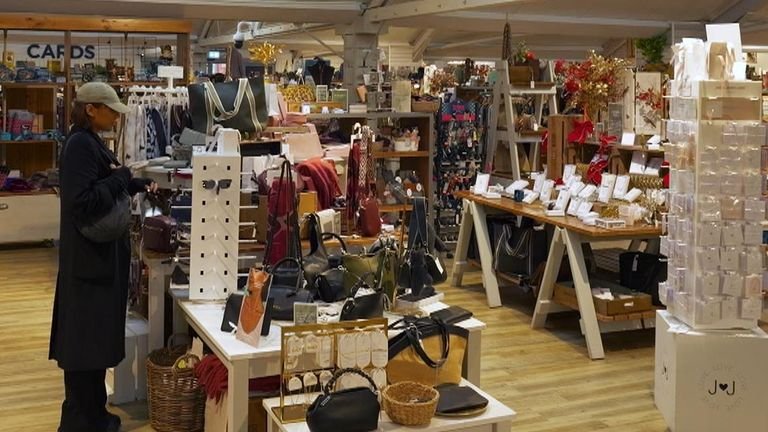 Gurpreet Narwan is seen at the garden centre while being shown how Facewatch works