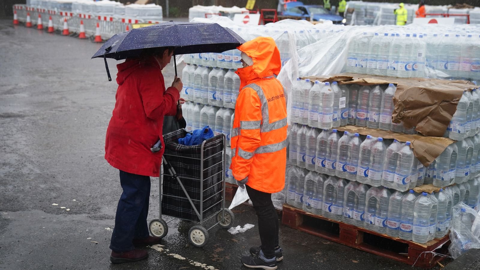 A South East Water customer arrives to collect bottled water in East Grinstead. Pic: PA
