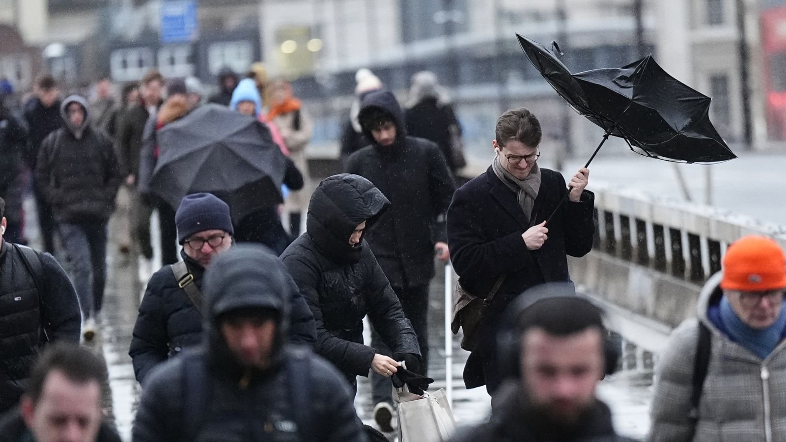 Commuters battle with the wintry conditions on London Bridge. Pic: PA