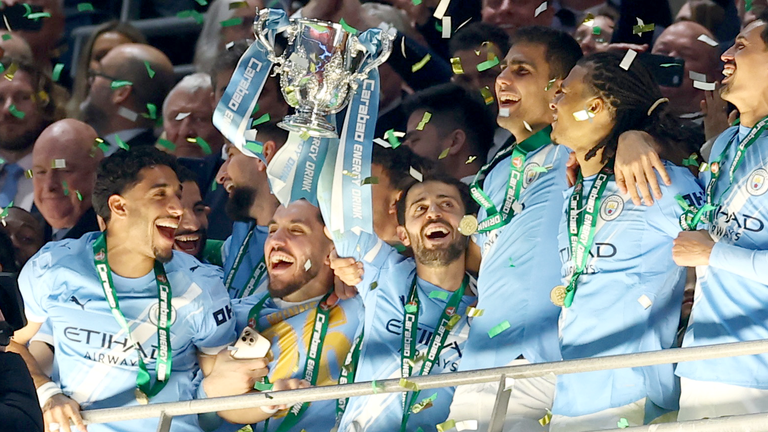 Bernardo Silva lifts the trophy surrounded by teammates. Pic: Action Images/Reuters