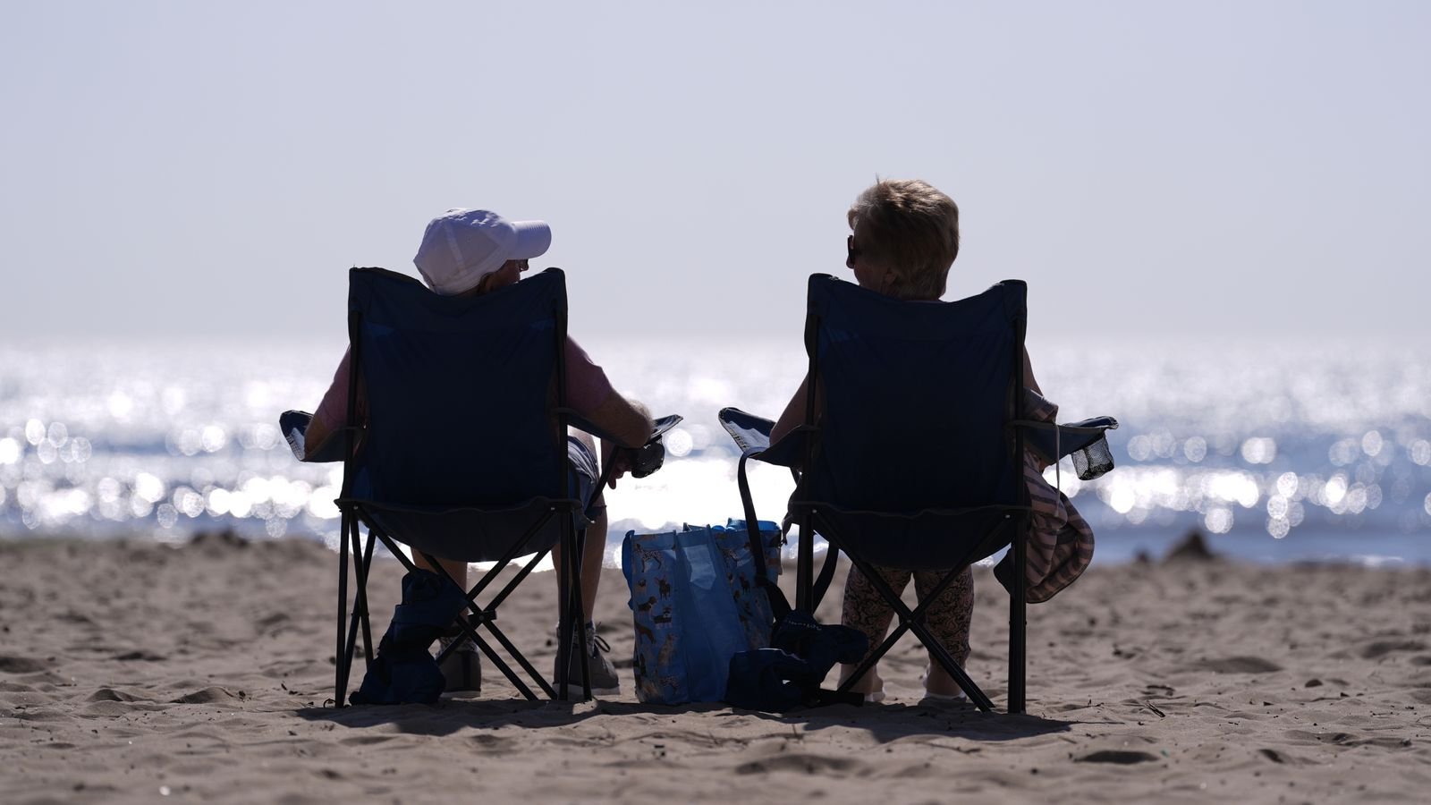 People relax in chairs on the beach in Bournemouth, Dorset. Pic: PA